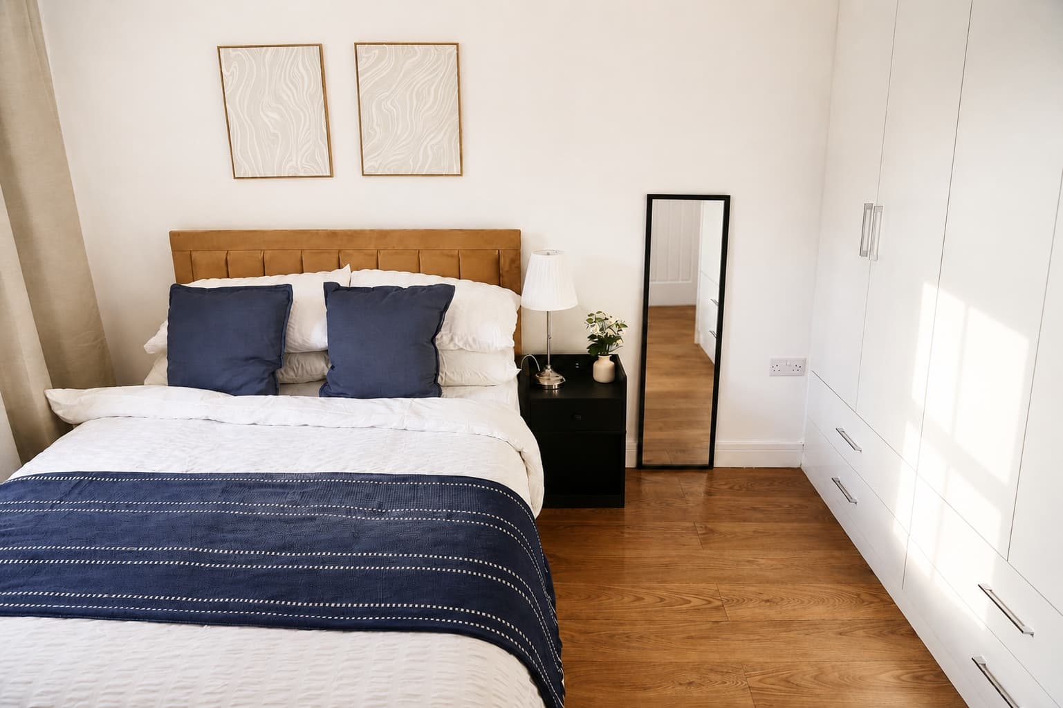 Double bedroom with navy and white bedding